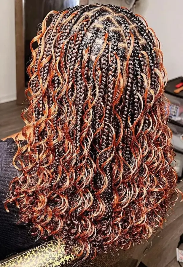 Back view of medium-length boho braids with copper curly ends