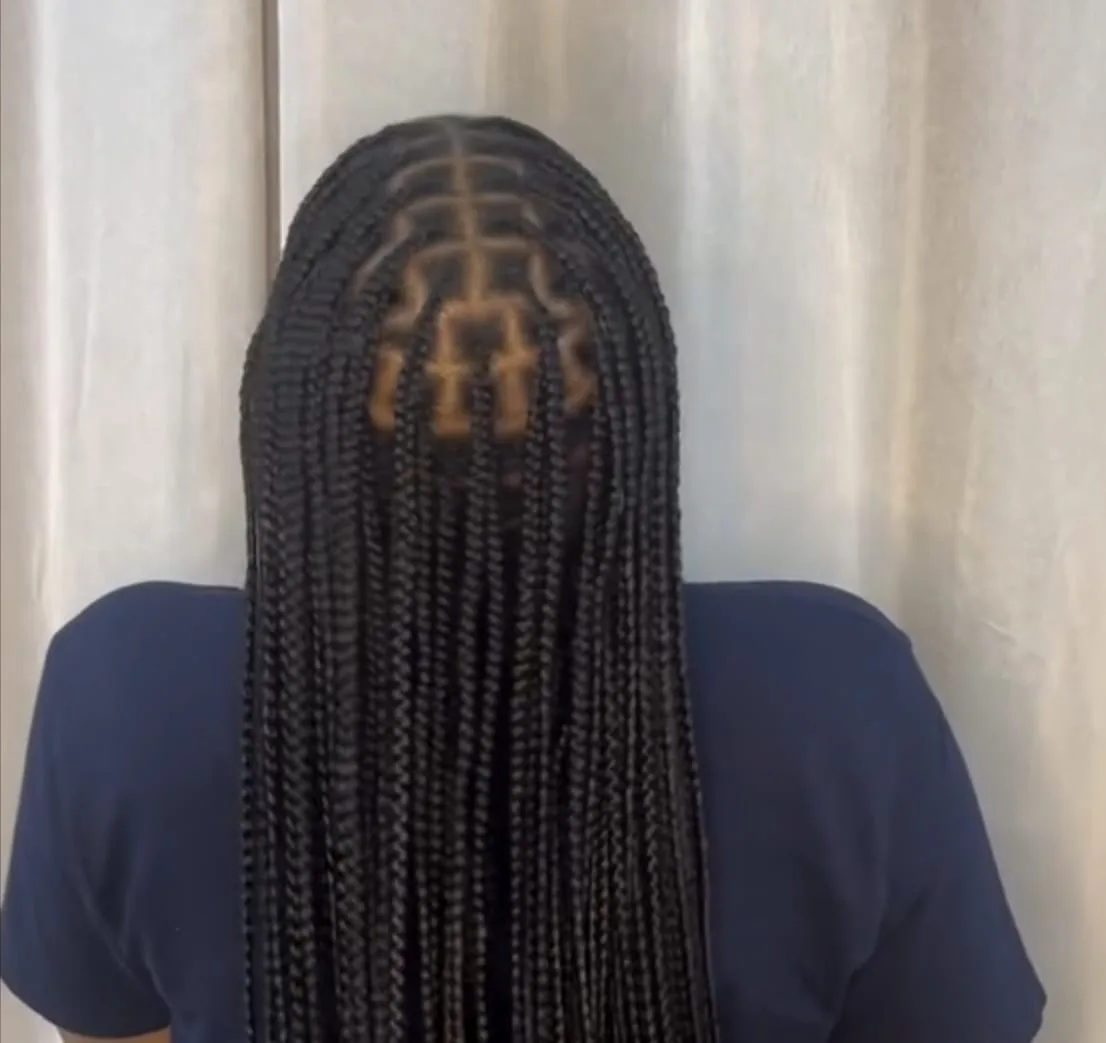 Back view of long small knotless braids with neat grid parting